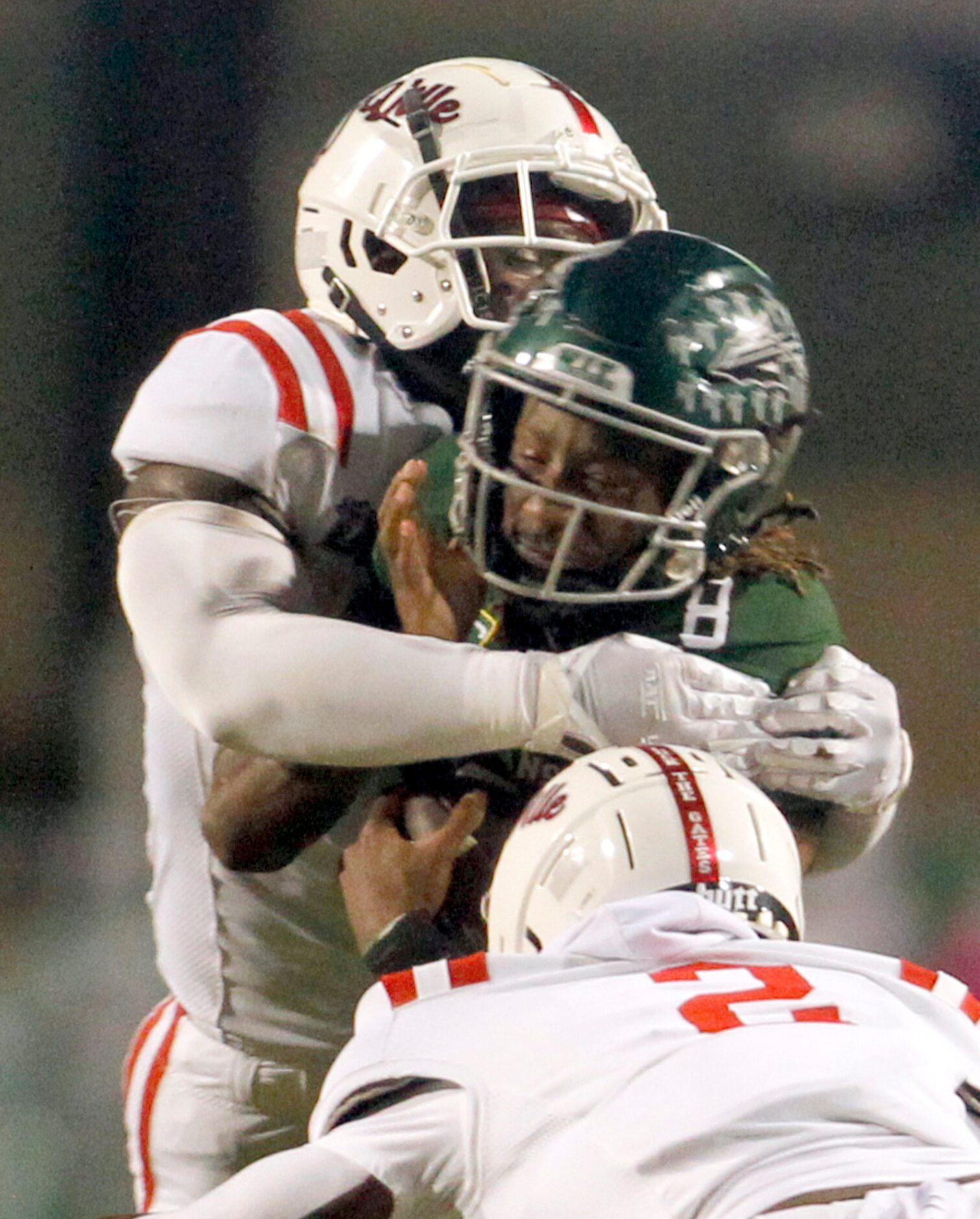 Waxahachie quarterback Ramon McKinney Jr (8) is sandwiched between Duncanville defensive...