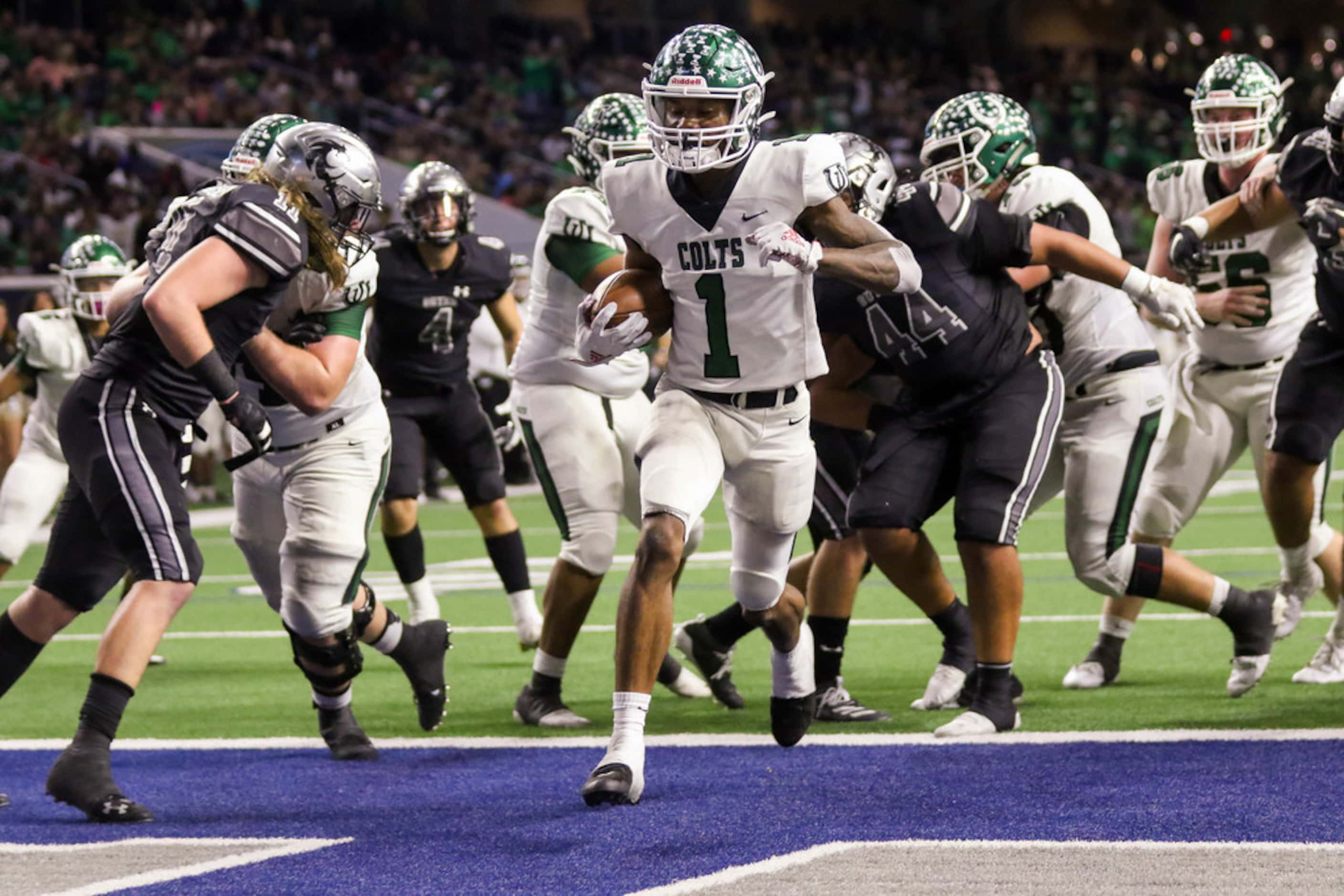 Arlington's wide receiver Charles Brown (1) scores runs past Guyer's defense to score a...