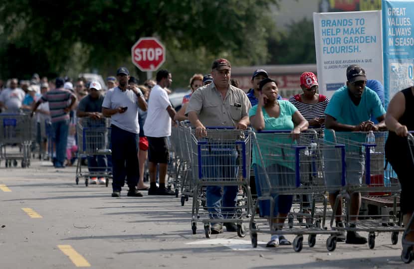Residents wait hours in long lines at a Lowes, in Beaumont, Texas, August 31, 2017. 