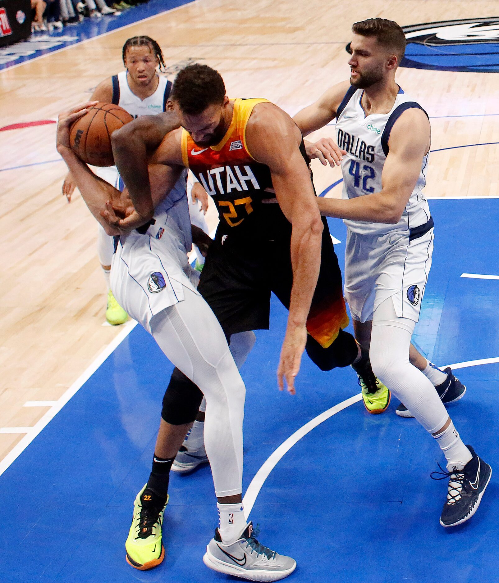 Dallas Mavericks forward Dorian Finney-Smith (behind) wrestles the ball away from Utah Jazz...