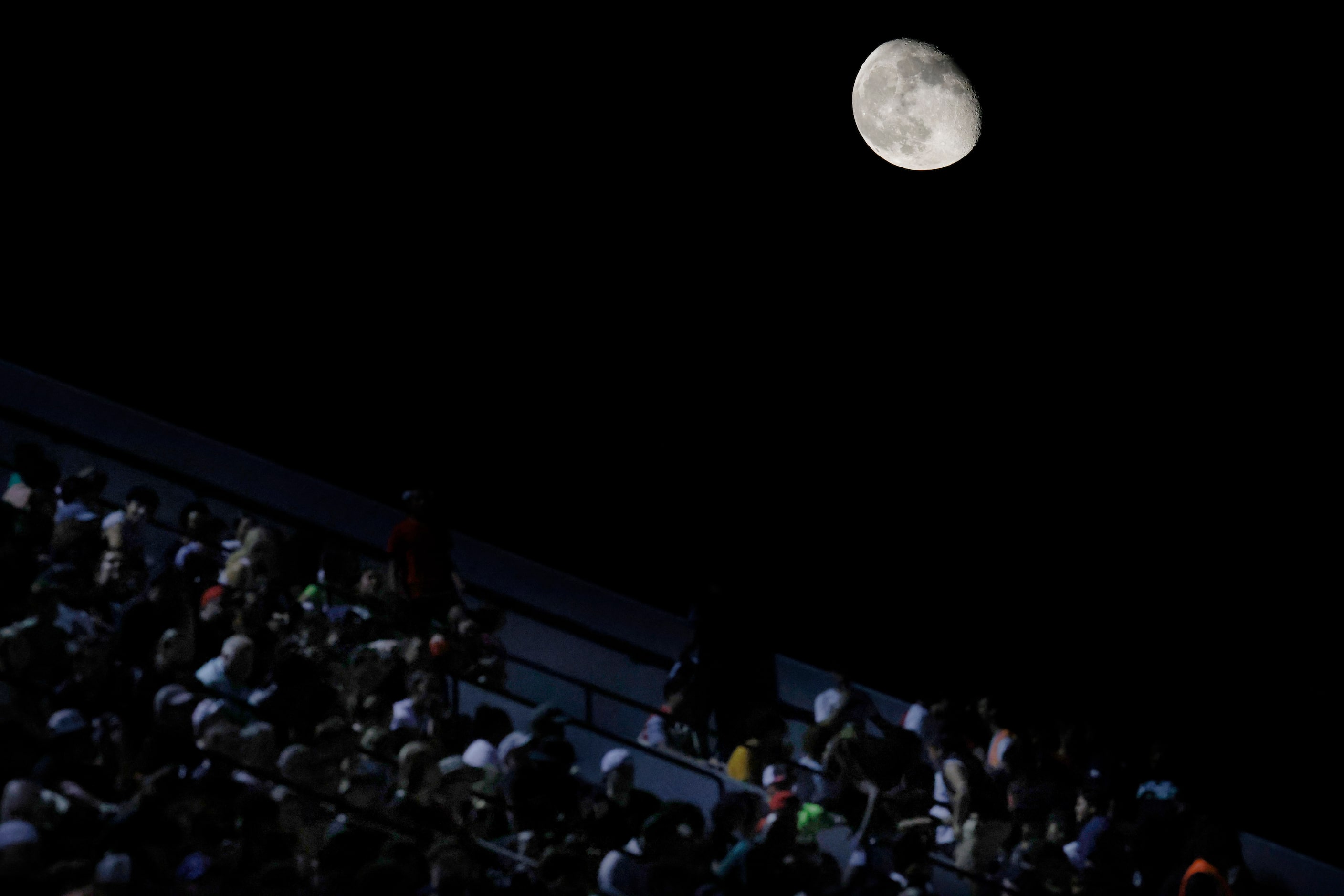 The moon rises above Pennington Field during the second half of a District 4-6A game between...