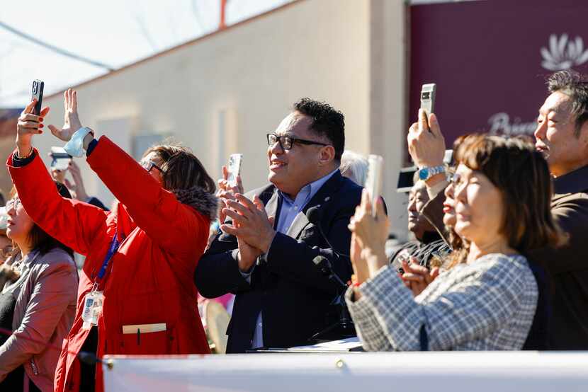 Dallas Deputy Mayor Pro Tem Omar Narvaez (center) claps as a new Korean and English street...