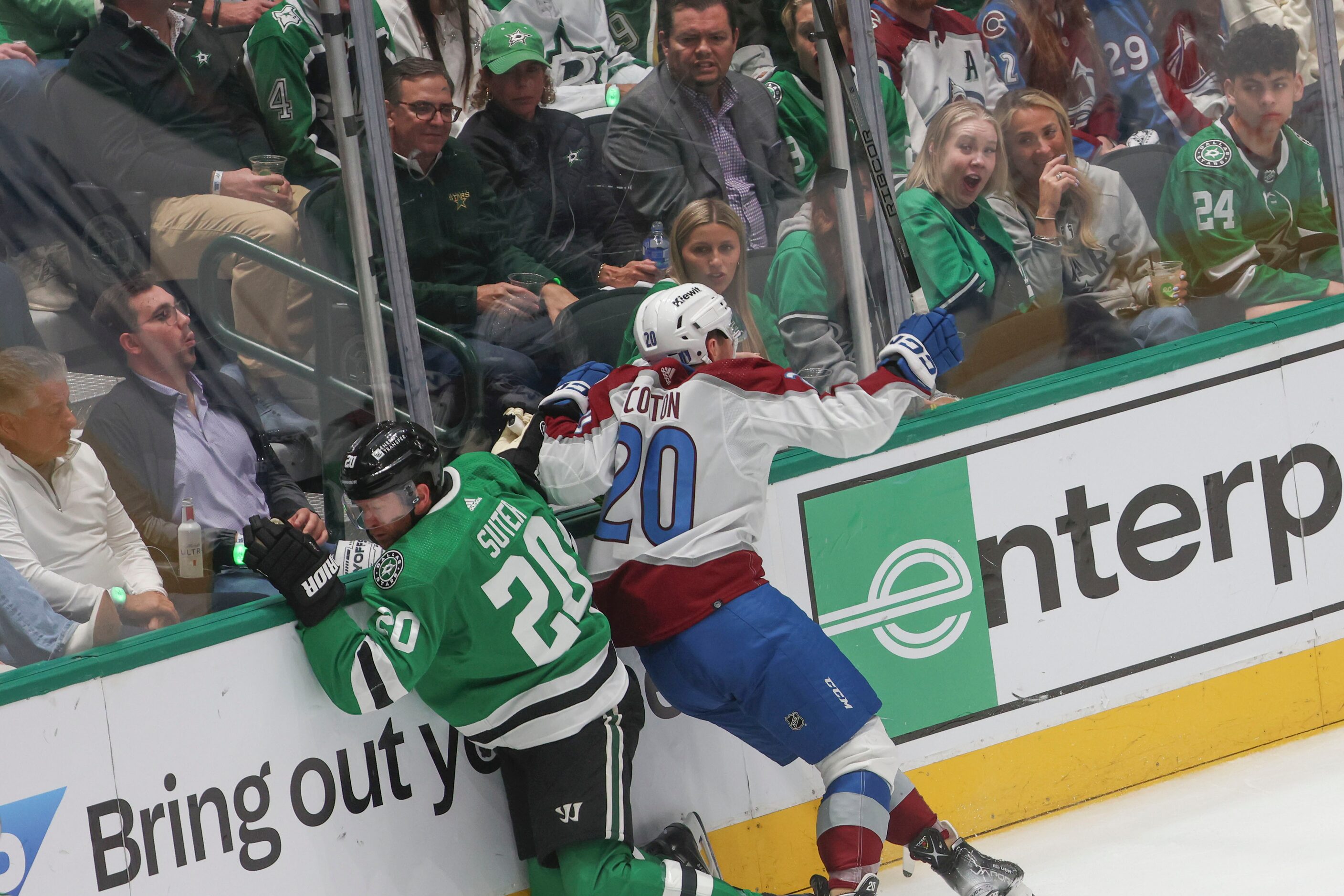 Crowd reacts as Dallas Stars defenseman Ryan Suter (left) slams with Colorado Avalanche...