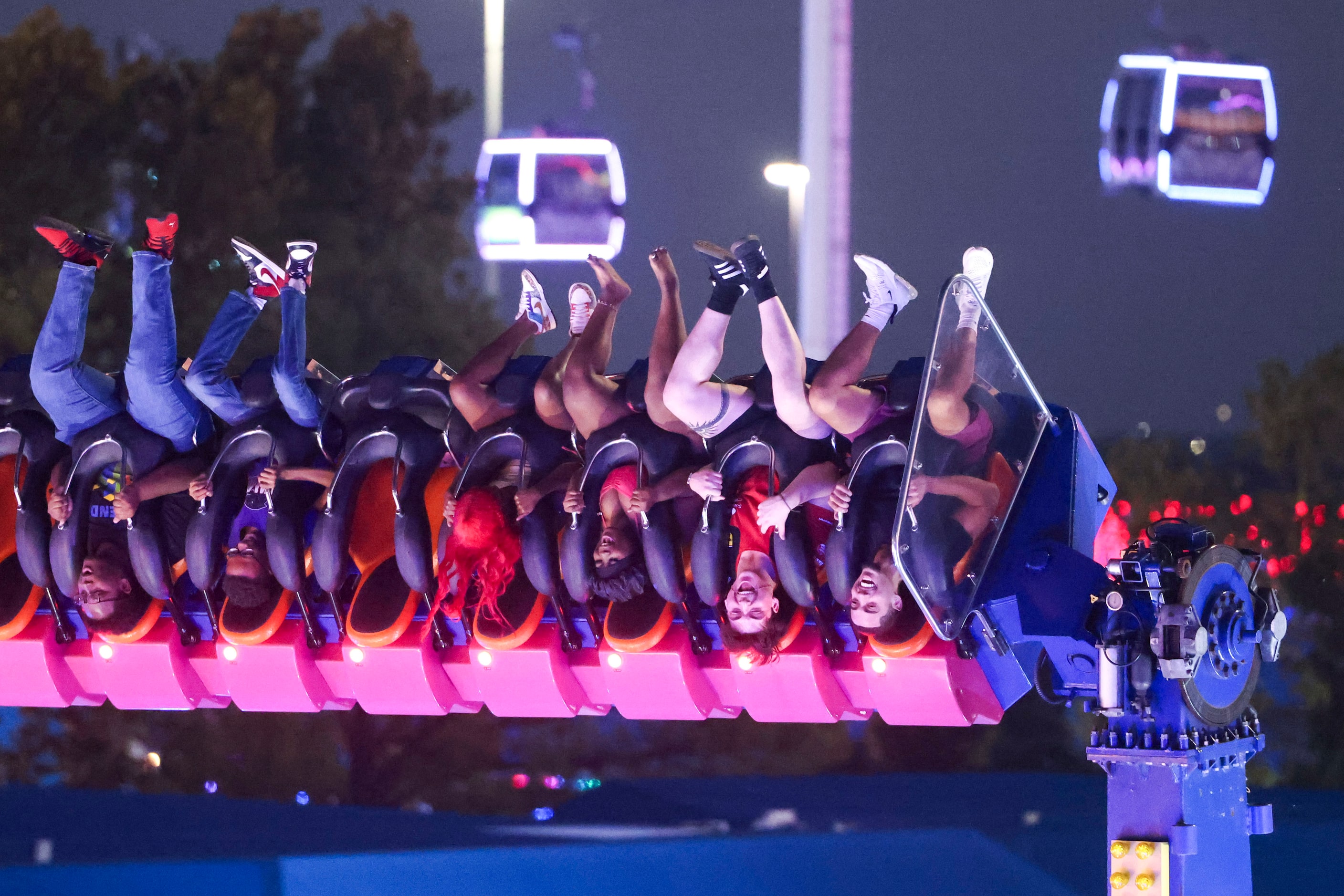 Fairgoers hang upside down on a ride during State Fair of texas, on Saturday, Sept. 28,...