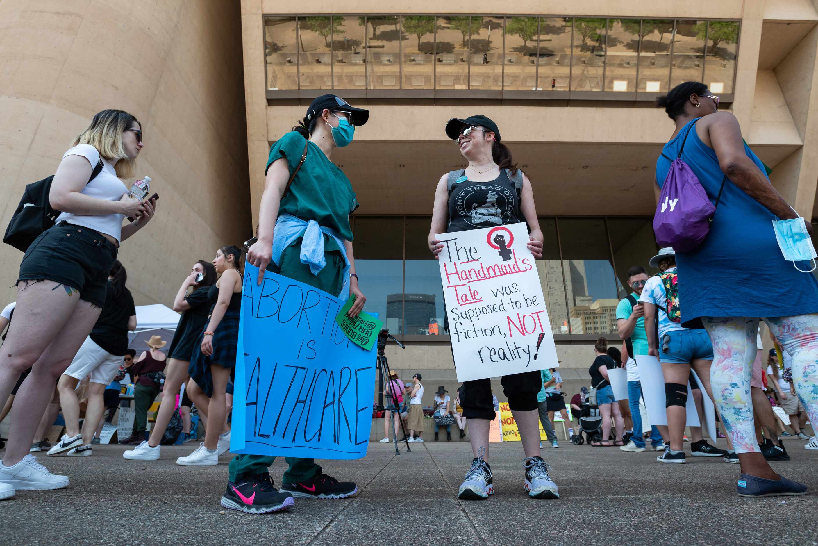 Emilie Nguyen, 28, left wearing a face mask, and Heather Hall, 42, right, meet for the first...