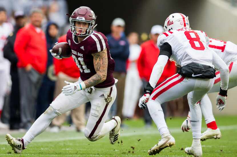 Texas A&M Aggies tight end Jace Sternberger (81) runs the ball ahead of Ole Miss Landsharks...