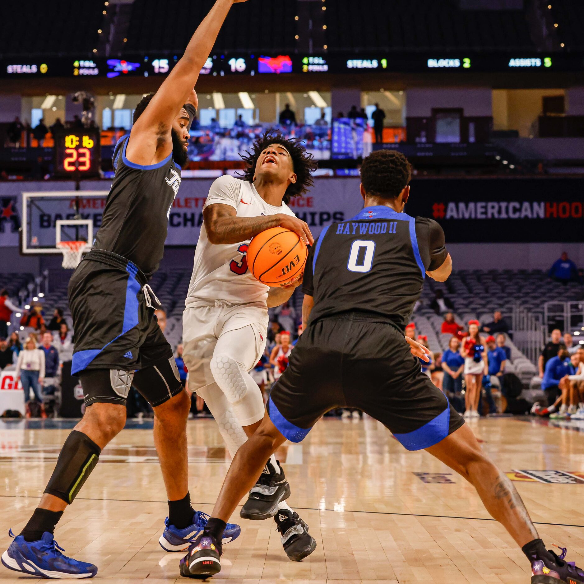 Southern Methodist Mustangs guard Kendric Davis (3) goes for a shot between Tulsa Golden...