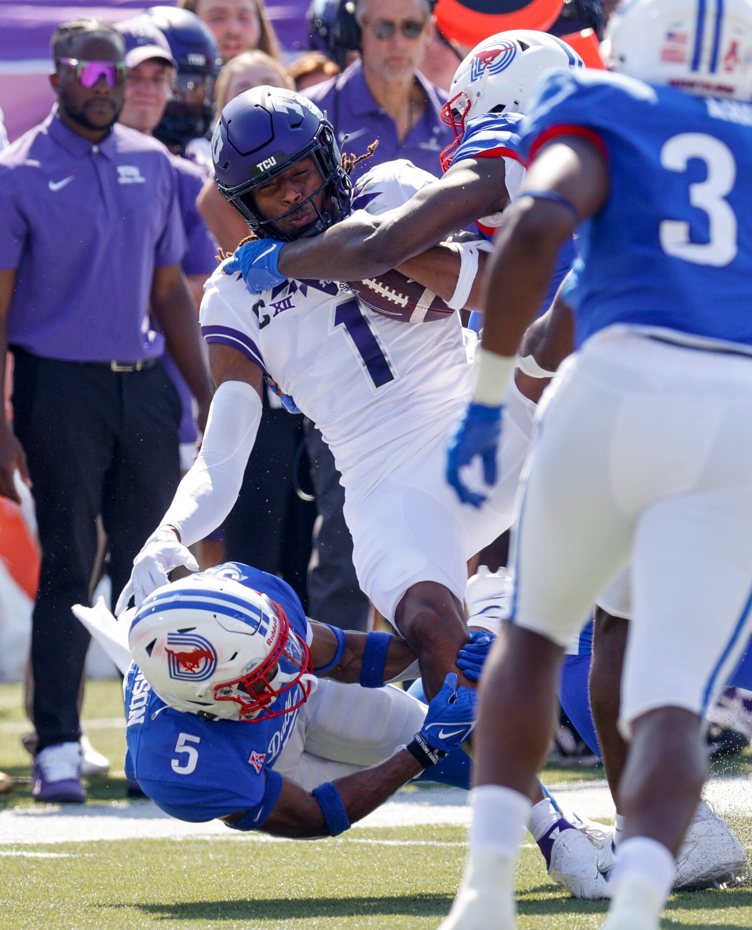 SMU cornerback Ar'mani Johnson (5) tackles TCU wide receiver Quentin Johnston (1) during the...