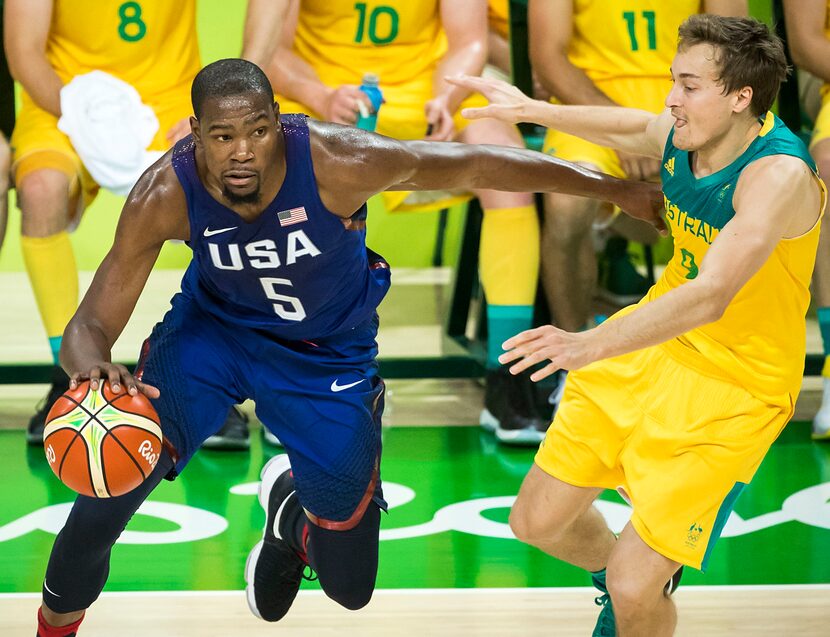 Kevin Durant (5) of the United States drives the ball around Ryan Broekhoff (9) of Australia...