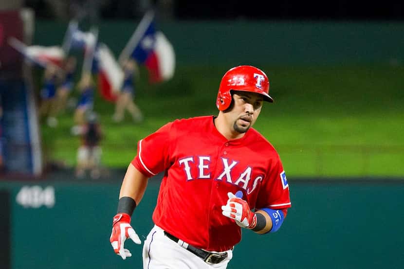 Texas Rangers designated hitter Carlos Beltran rounds the bases after hitting a solo home...