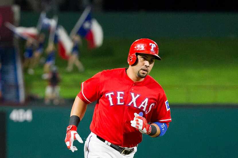 Texas Rangers designated hitter Carlos Beltran rounds the bases after hitting a solo home...