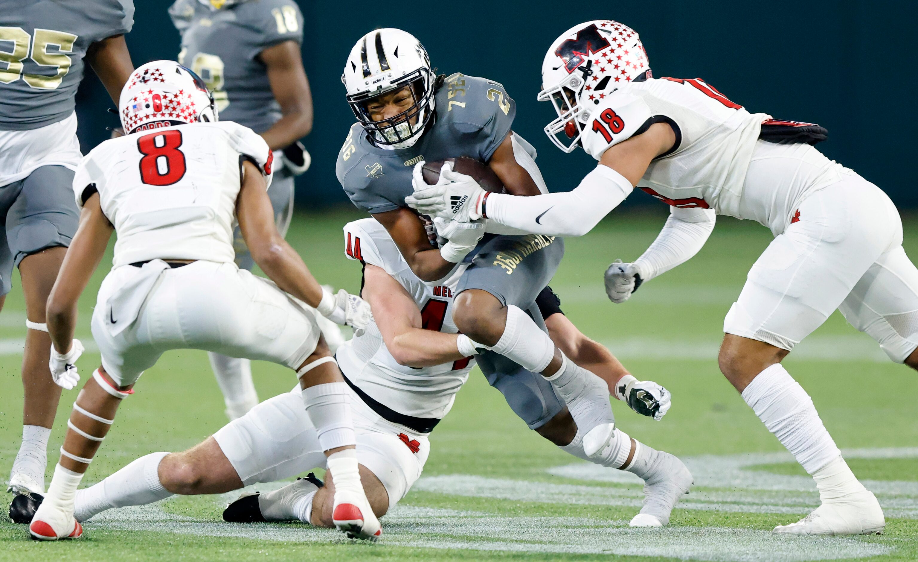 South Oak Cliff running back Danny Green (21) tries to break free of a tackle by Melissa...