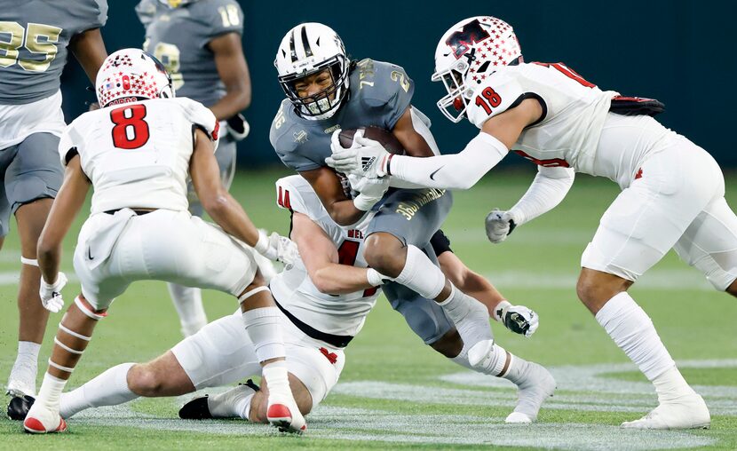 South Oak Cliff running back Danny Green (21) tries to break free of a tackle by Melissa...