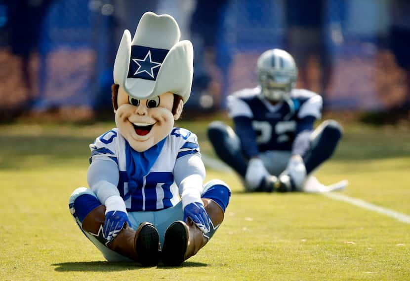 Dallas Cowboys mascot Rowdy stretches with the tram before afternoon practice at training...