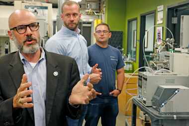 University of North Texas chemistry professor Guido Verbeck (left) talks about a...