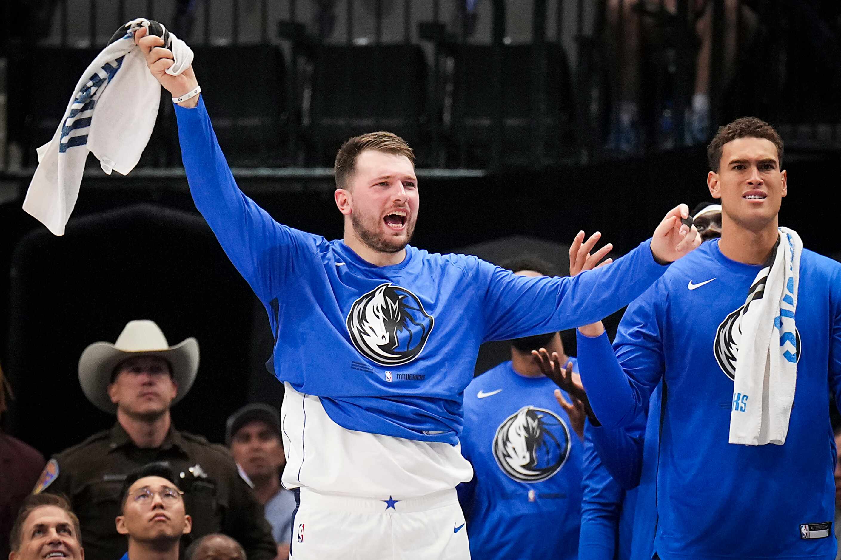Dallas Mavericks guard Luka Doncic (left)nreacts to a call from the bench during the first...
