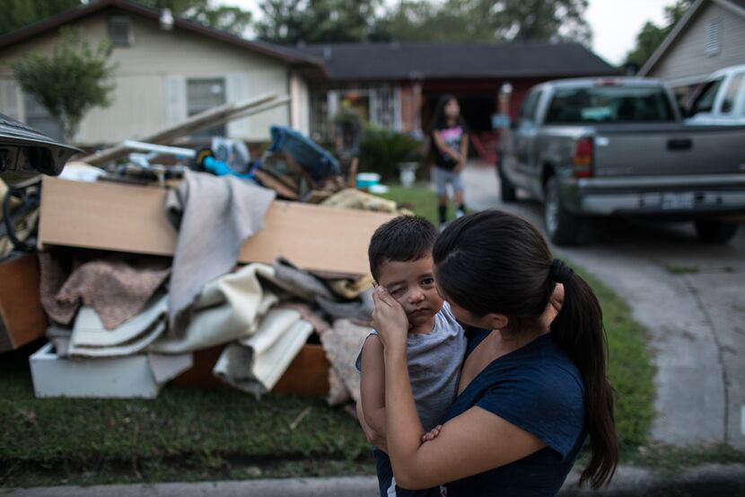 Sabrina Rodriguez wiped away a tear as she comforted her son, Eder Cantero, 2, outside their...