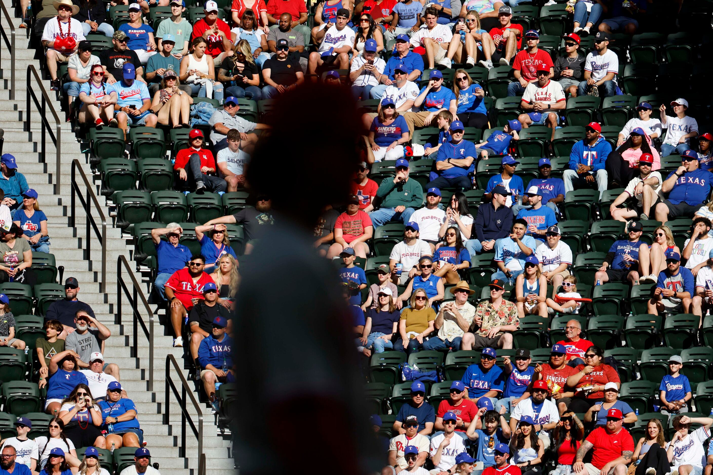 Fans watches during the sixth inning of a baseball game between Texas Rangers and...