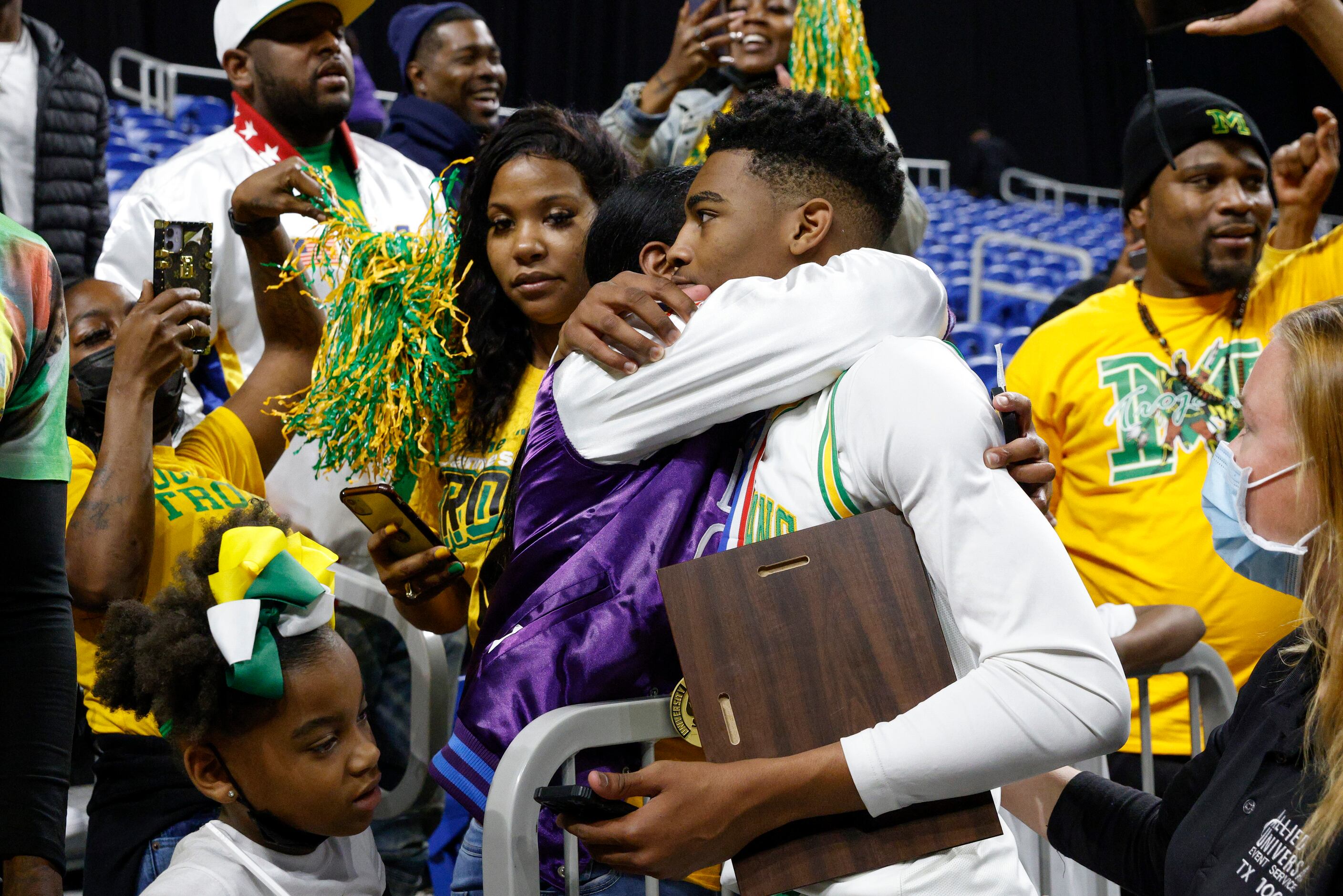 Madison forward Rodney Geter (13) shares an embrace after winning the Class 3A state...