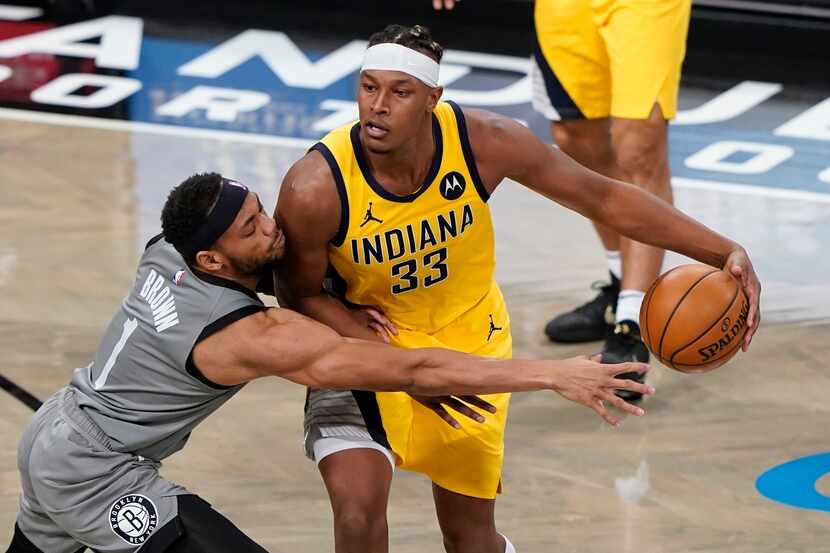 Indiana Pacers' Myles Turner protects the ball from Brooklyn Nets' Bruce Brown (1) during...