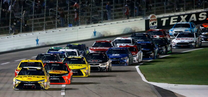 Carl Edwards (19) leads the pack of cars during Duck Commander 500 at Texas Motor Speedway...