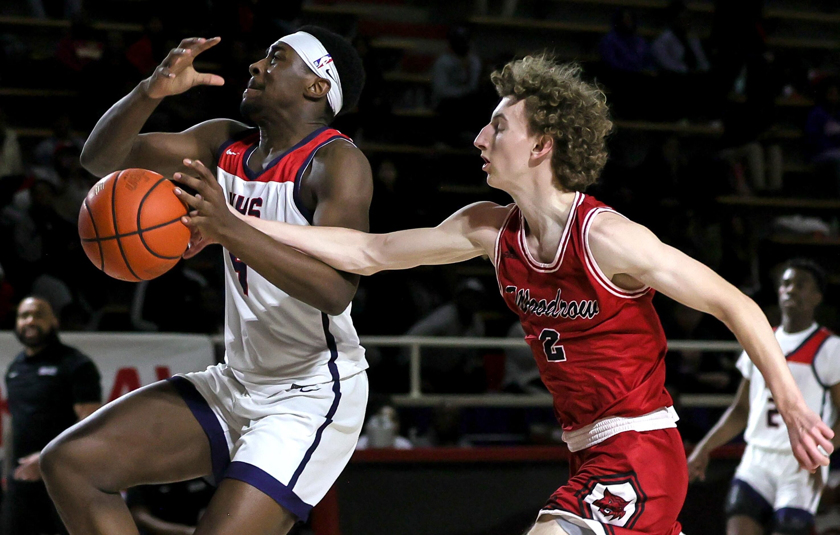 Kimball forward DaCannon Wickware (4) tries to get stripped on the ball against Woodrow...