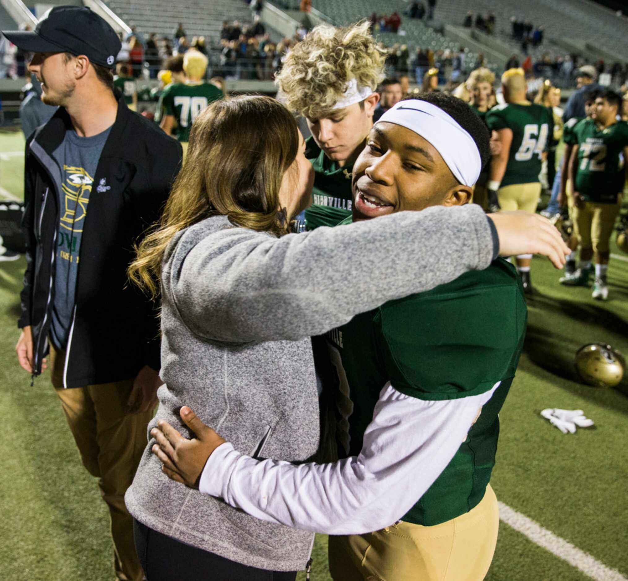 Birdville running back Laderrious Mixon (9) gets a hug from Ali Earle after a 29-27 win over...