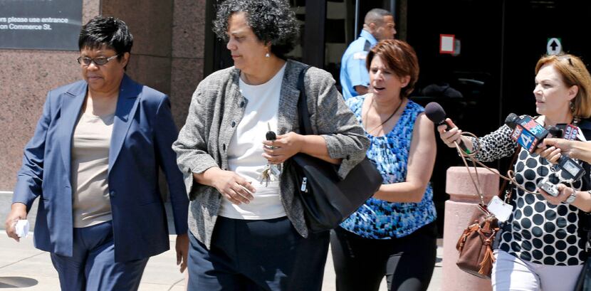 Kathy Nealy (left) left the federal courthouse in Dallas in July 2014 after being charged in...