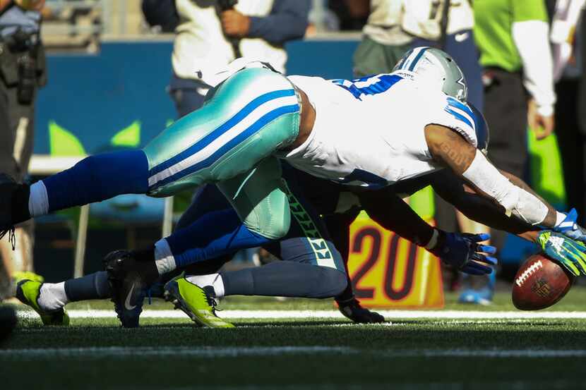 Dallas Cowboys running back Ezekiel Elliott (21) attempts to recover his own fumble during...