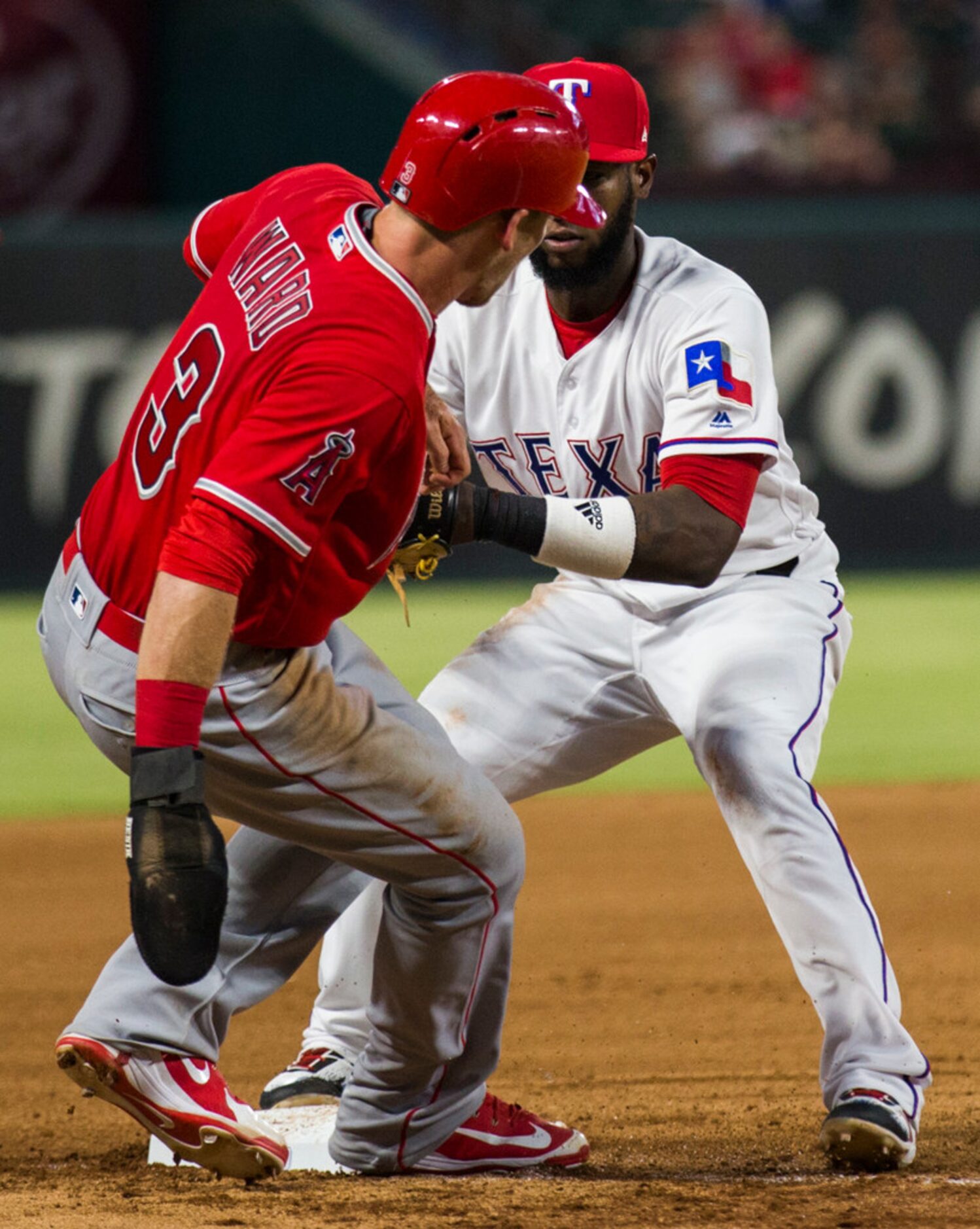 Texas Rangers shortstop Jurickson Profar (19) tags out Los Angeles Angels third baseman...