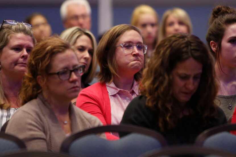 Julie Vazquez,center, fights back tears as a young student speaks of the kindness, love and...