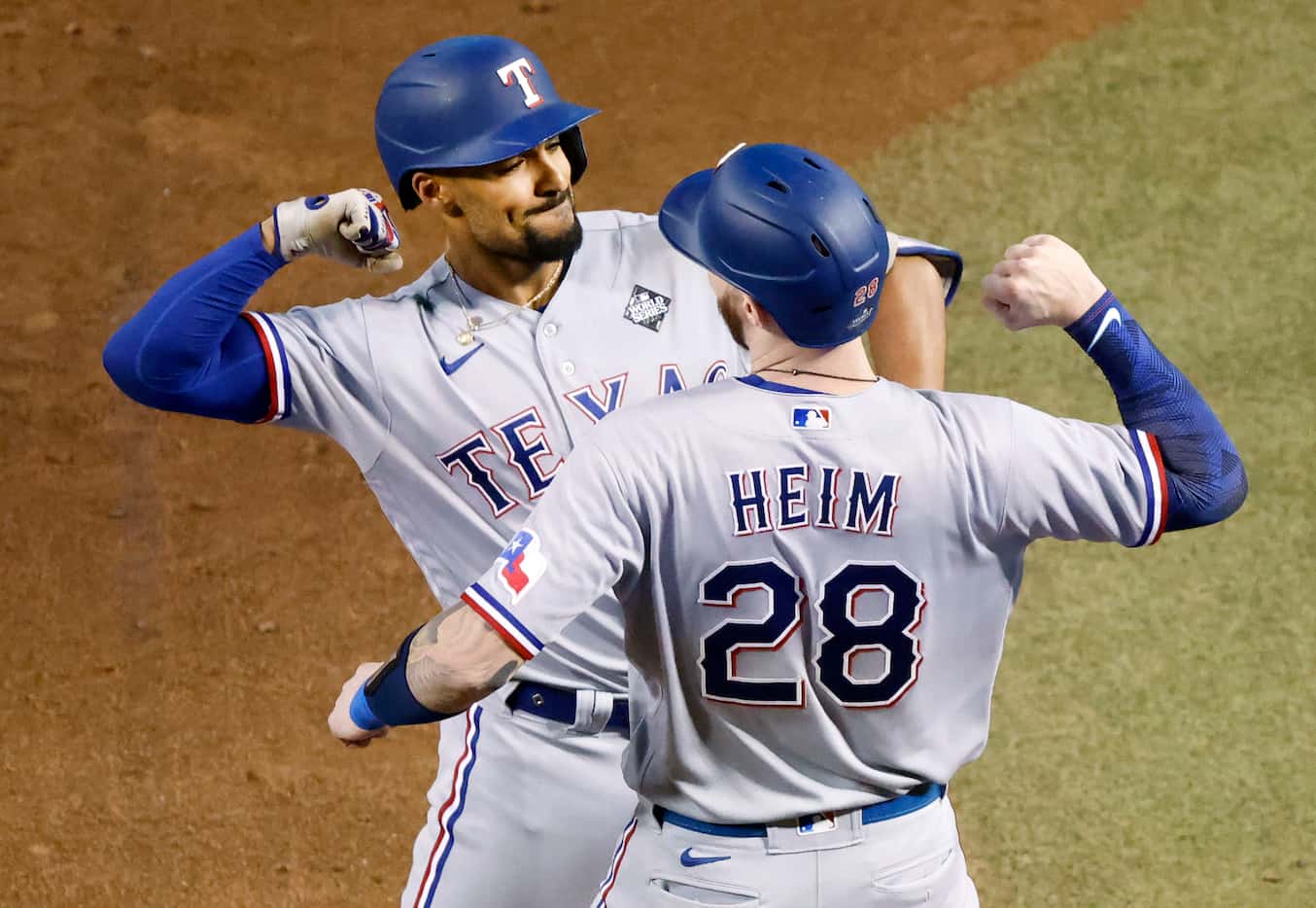 Texas Rangers second baseman Marcus Semien celebrates with Jonah Heim after hitting a...