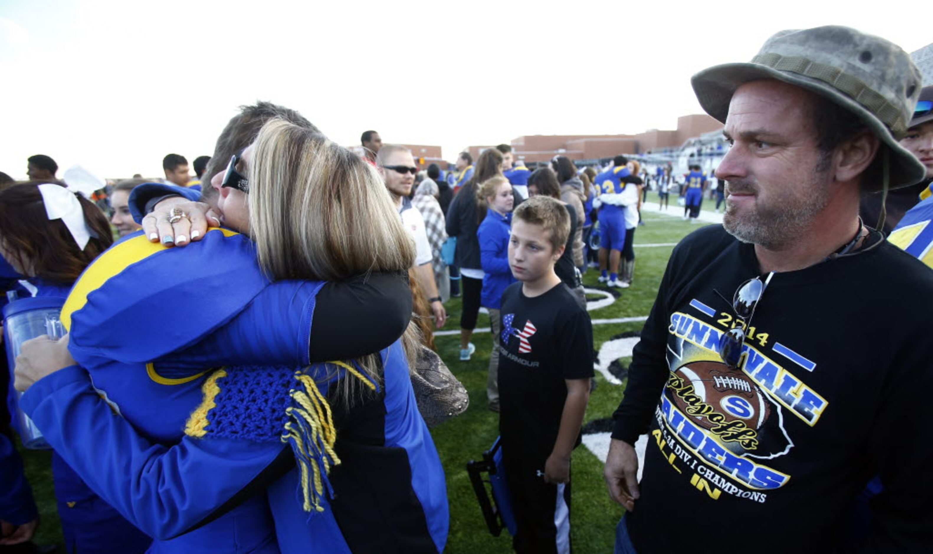 TXHSFB Sherry Maness, hugs her son Brady Maness (60), as father Sean Maness looks on after...