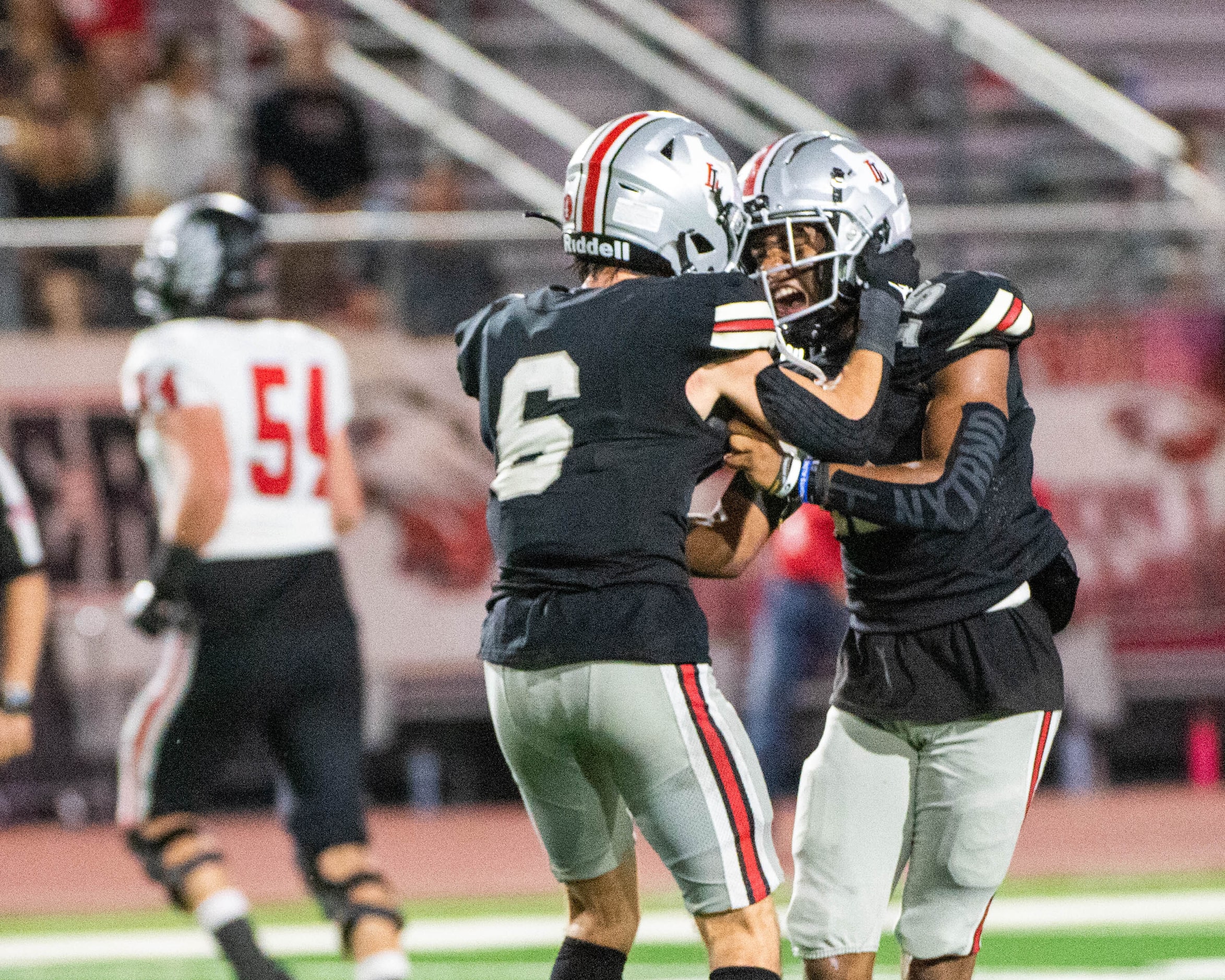 Lovejoy's Gabe Joyner (6) and Aarren Marshall (15) celebrate Marshall’s interception in the...