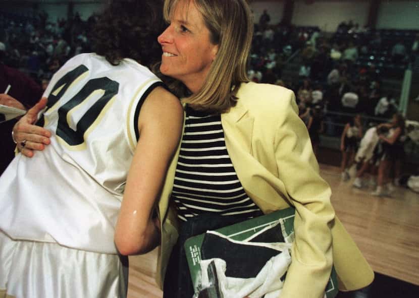 1/5/98---Mansfield girls basketball coach Samantha Morrow gets a hug from senior Robyn...