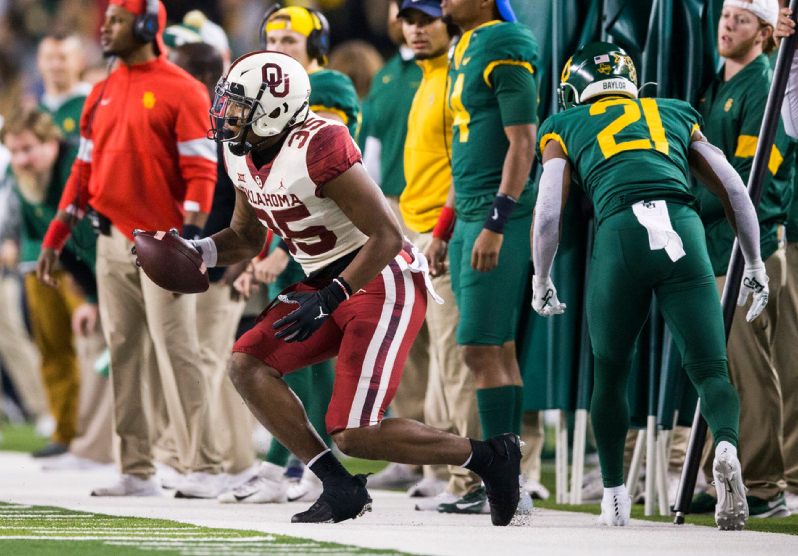 Oklahoma Sooners linebacker Nik Bonitto (35) is tackled by Baylor Bears quarterback Charlie...