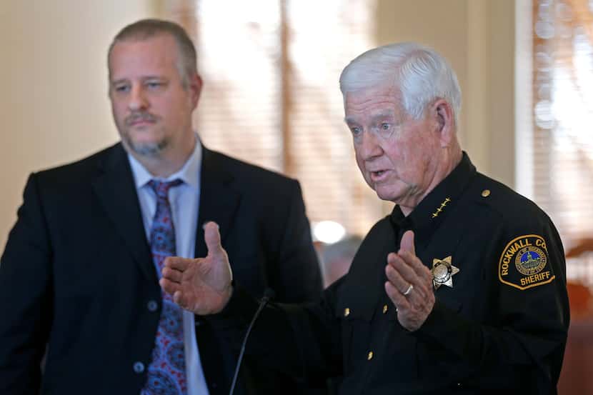 Sheriff Harold Eavenson (right) answered questions next to Norman Parrish, deputy director...