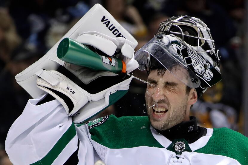 Dallas Stars goalie Landon Bow squirts water in his face during a timeout after replacing...