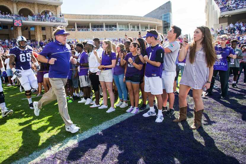 TCU head coach Gary Patterson leads his team onto the field before an NCAA football game...