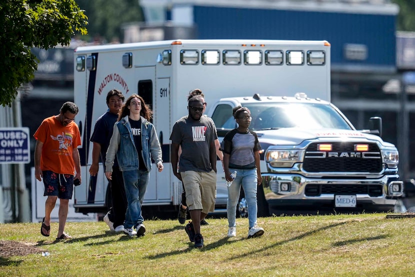 Students and parents walk off campus at Apalachee High School, Wednesday, Sept. 4, 2024, in...