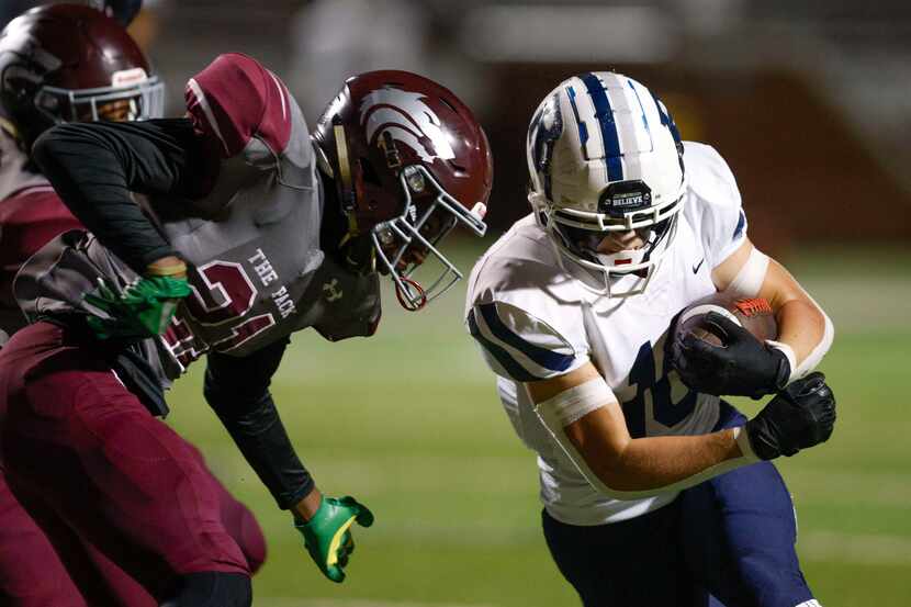 Mansfield Timberview safety Nathan TIlmon (21) tackles Richland running back Grant Cook (10)...