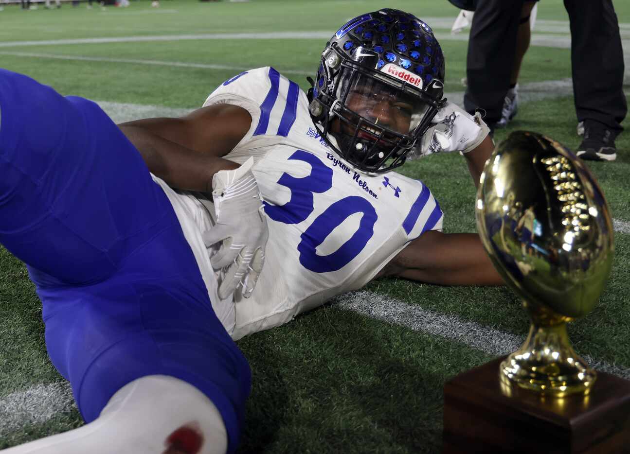 Byron Nelson's Jacoven Julian (30) is all smiles as he poses with the regional trophy...