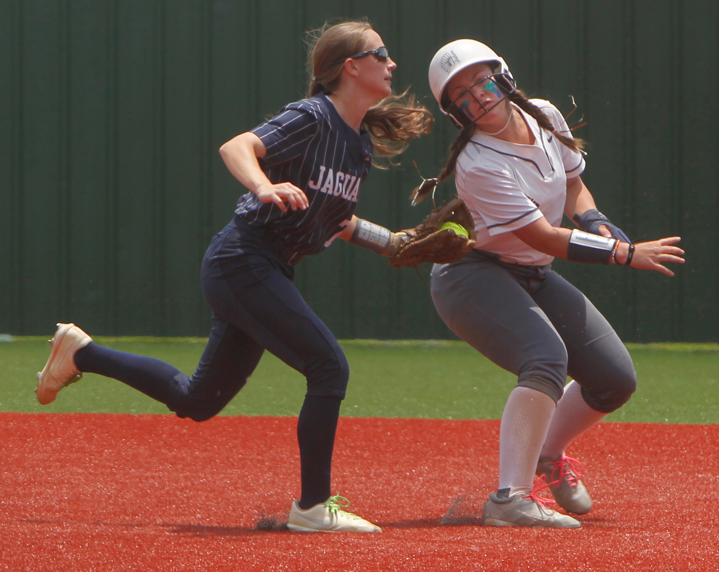 Keller's Sydona Meiser (12), right, is tagged out after getting caught in a rundown by...