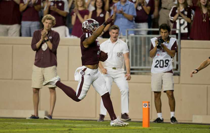 Texas A&M's Christian Kirk (3) crosses the goal line for a touchdown after returning a punt...