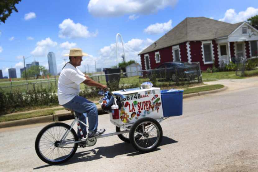 Noel Castro, an ice cream vendor, rode through the La Bajada neighborhood in West Dallas.