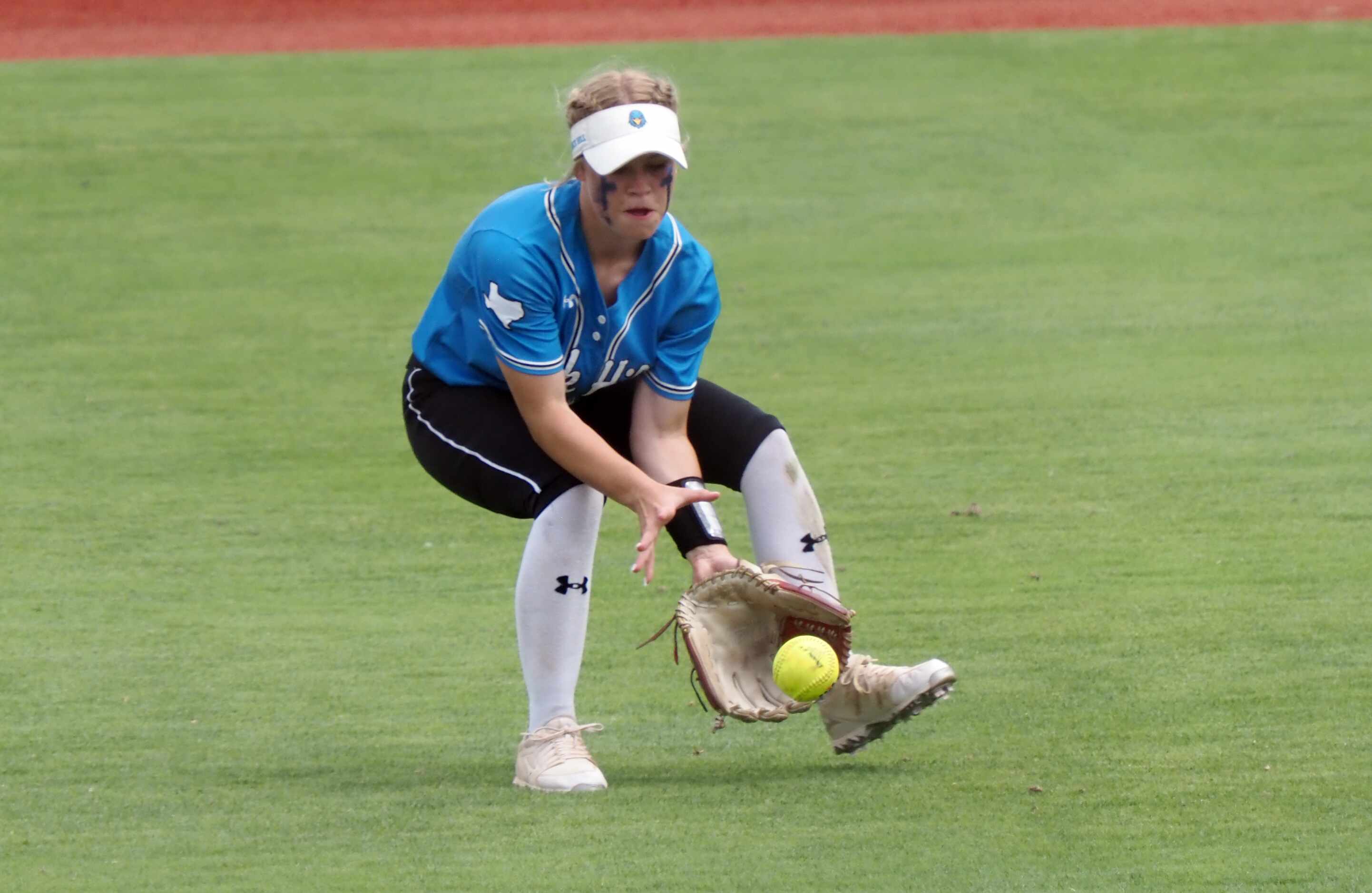 Prosper Rock Hill left fielder Leah Rinehart collects the ball against Montgomery Lake Creek...