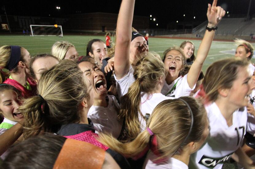 Members of the Southlake Carroll Lady Dragons celebrate their 2-1 double overtime victory...