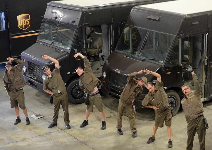 
Drivers do light stretching before heading out to make the day’s deliveries. UPS hopes its...