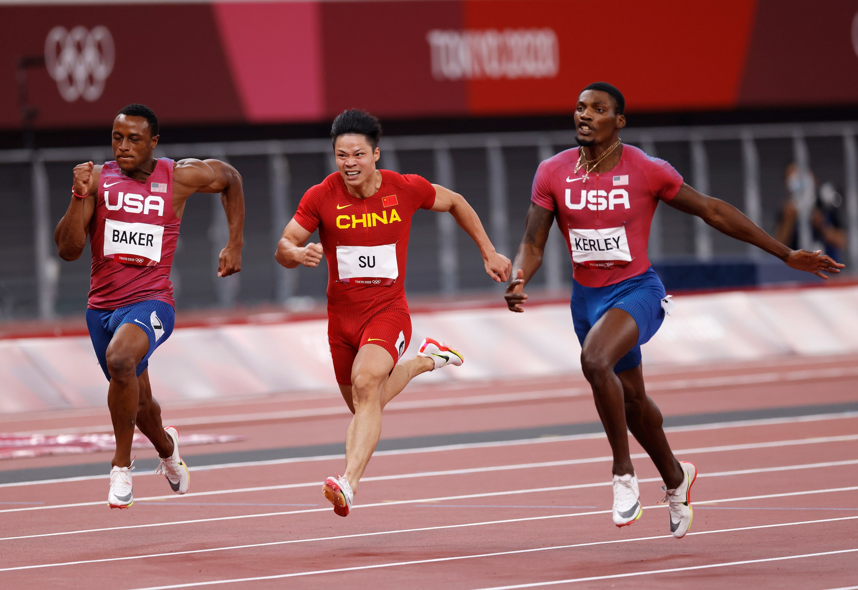 USA’s Ronnie Baker, Su Bingtian, and Fred Kerley race to the finish in the men’s 100 meter...