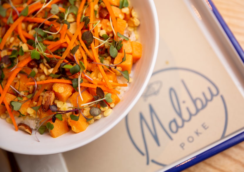 The sweet potato coconut curry bowl with carrot, basil, micro herbs, tempura flake and...